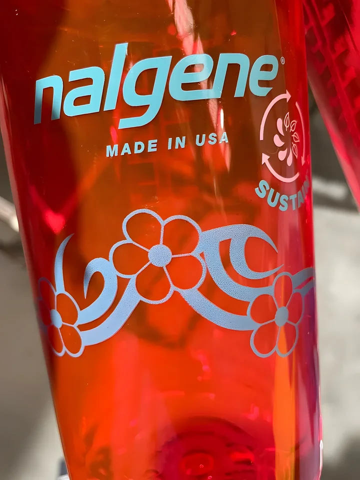 Red Nalgene bottle with a light blue floral band print